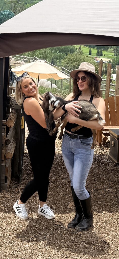 2 Ladies holding baby goats